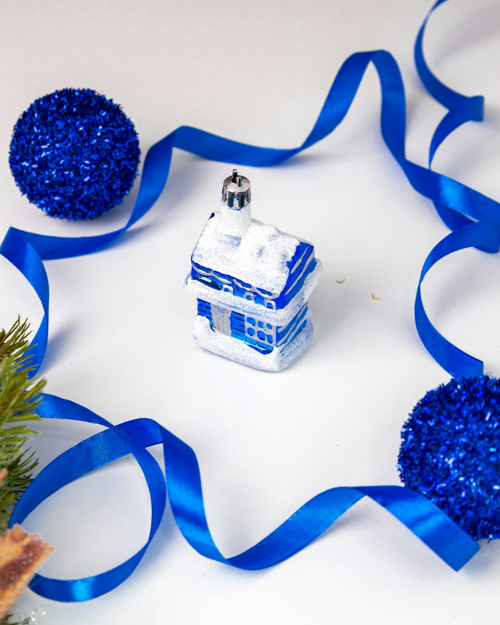 a christmas ornament with a blue ribbon around it