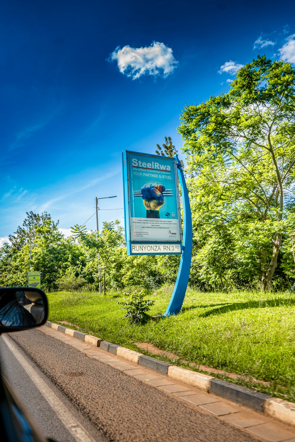 a blue sign on the side of a road