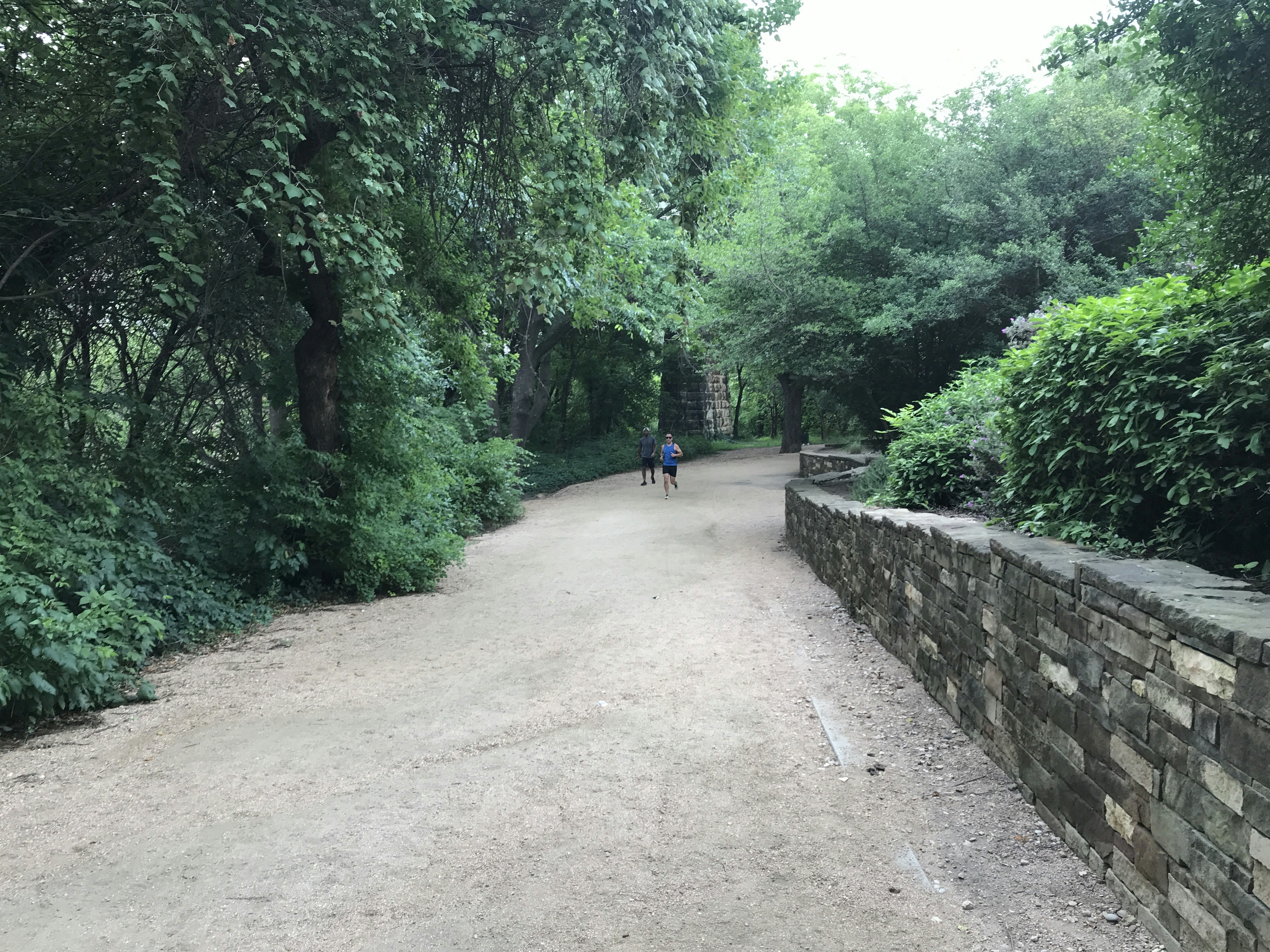 a person riding a bike down a dirt road