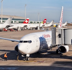 A warm customer service interaction at an airport booking counter with PeruAir Barcelona branding.