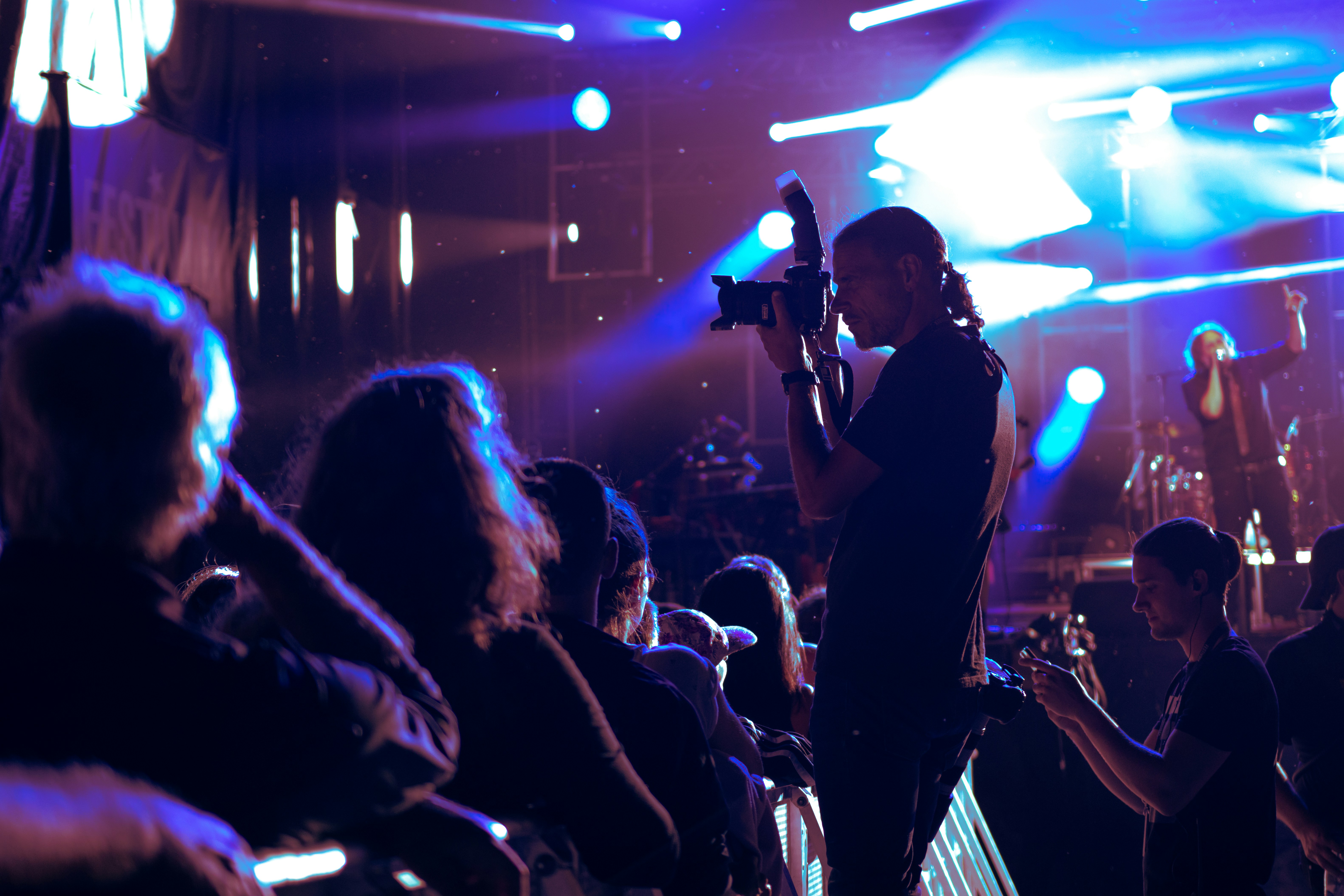 Raw concert photography with intense crowd energy and stage lights