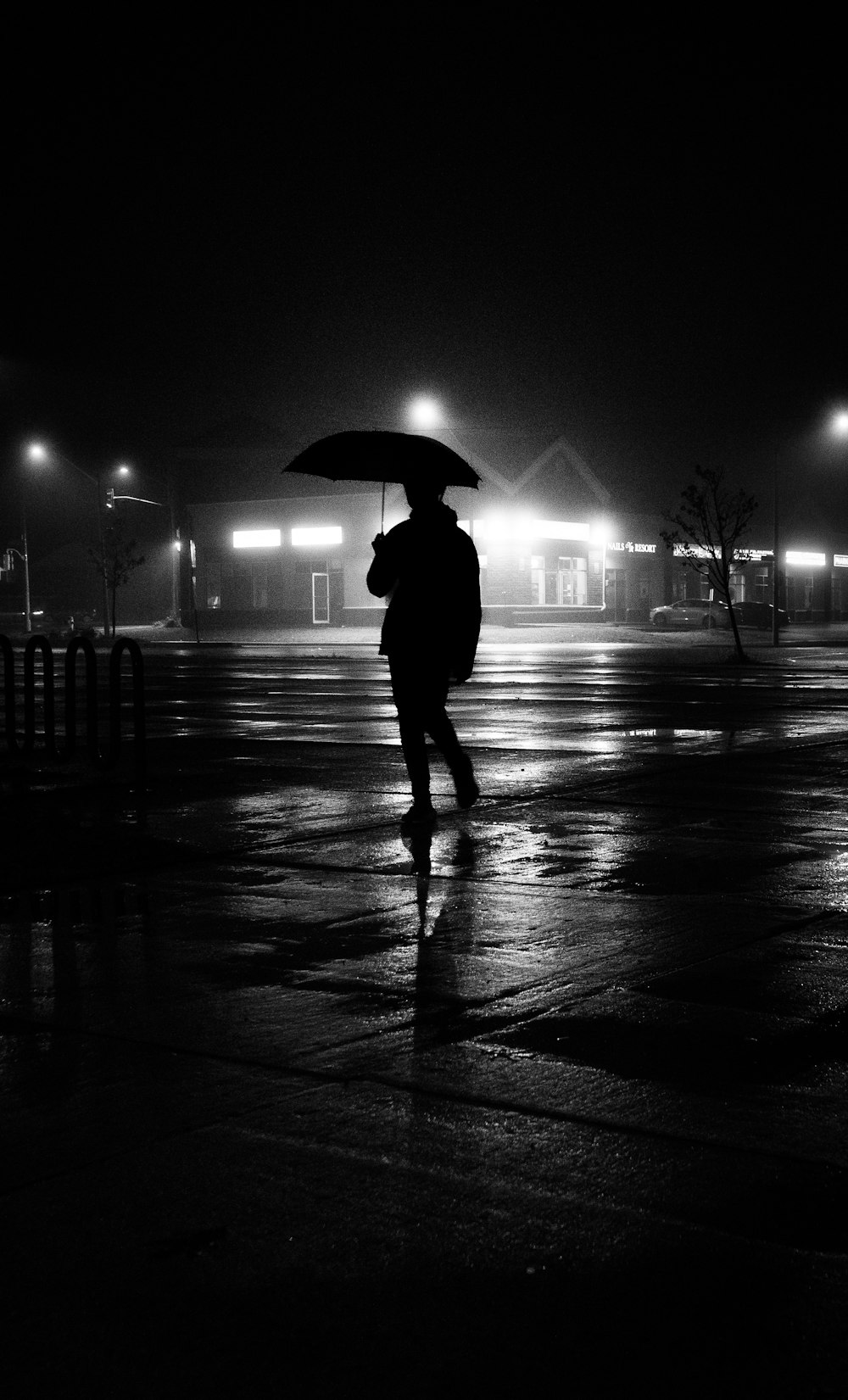 a person walking in the rain with an umbrella