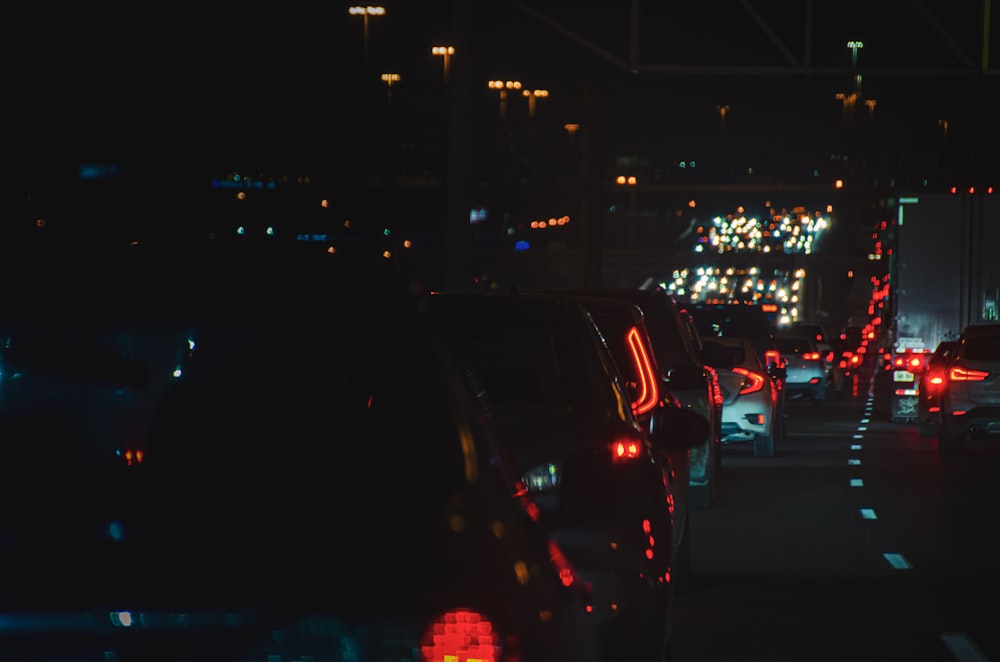 a city street filled with lots of traffic at night