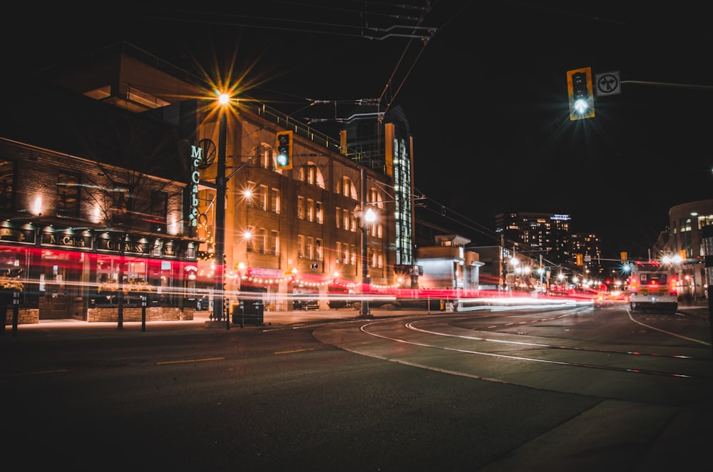 a city street filled with traffic at night