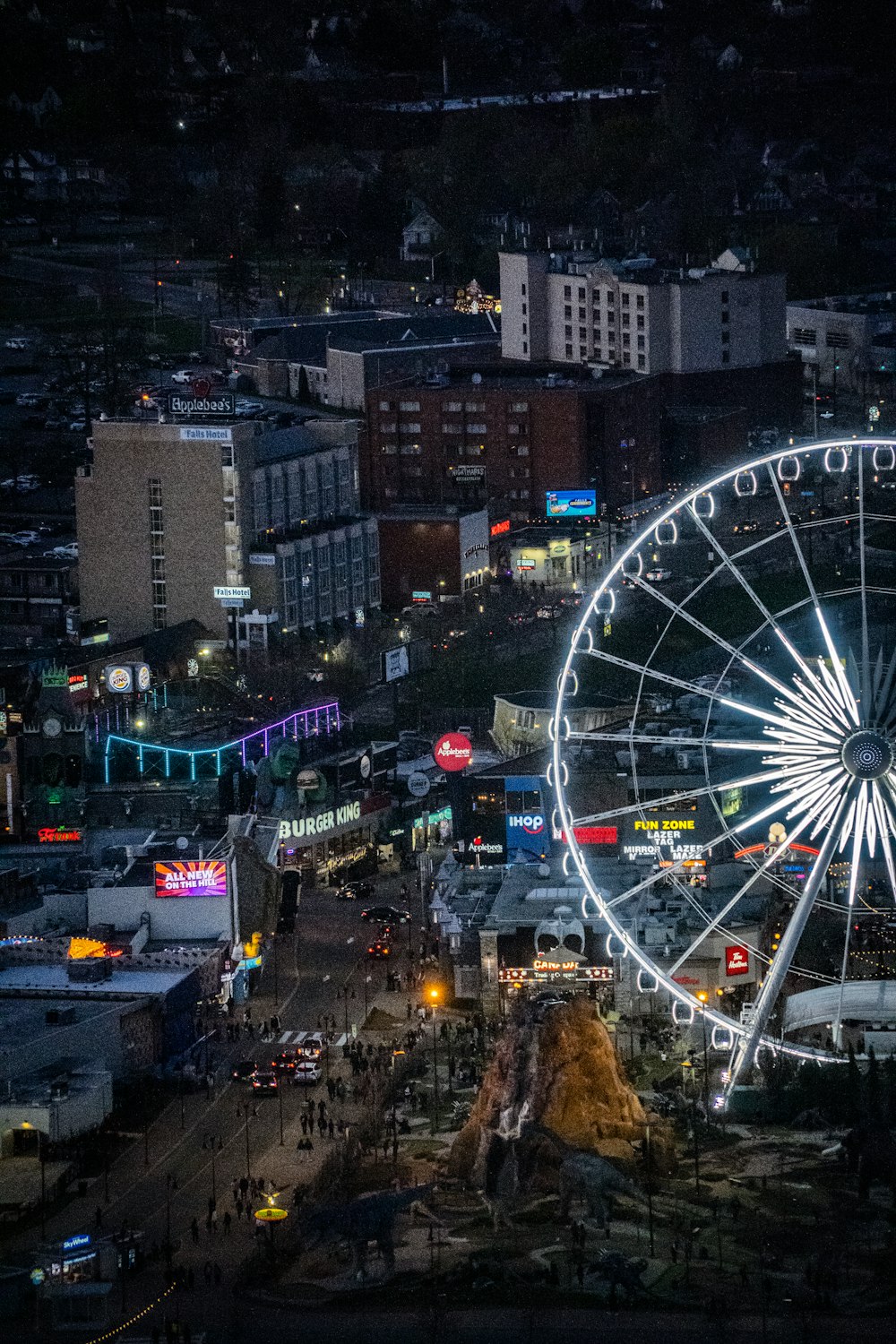 an aerial view of a ferris wheel at night