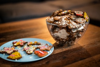 An assortment of colorful, handmade dog treats displayed on a wooden table.