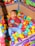 A joyful child engaged in speech therapy with a therapist using colorful toys.