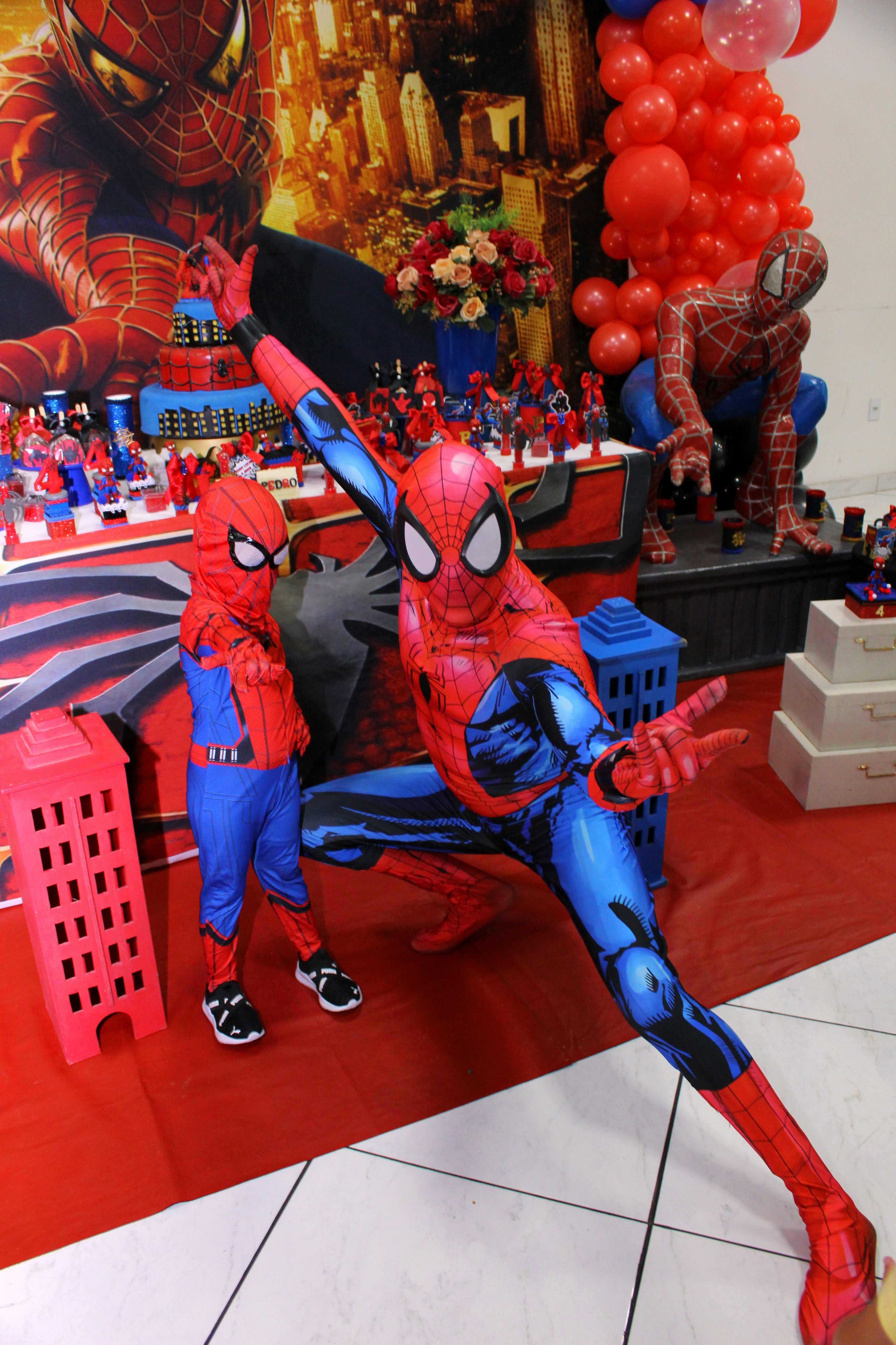 Spiderman themed party with red and blue web decorations and superhero details