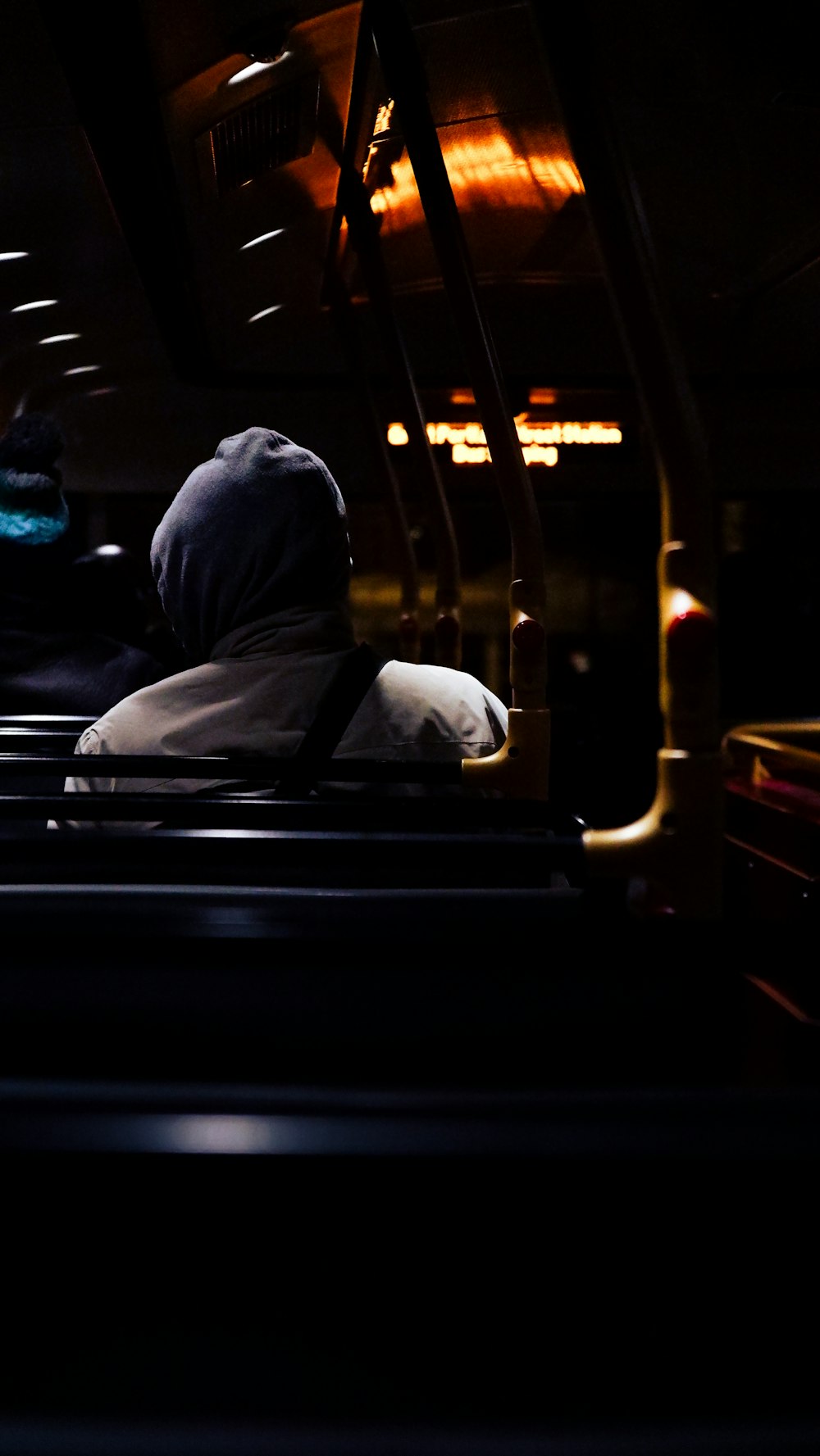 a person sitting on a bus in the dark