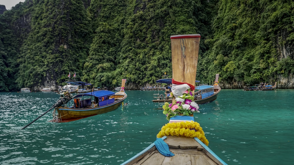 a row of boats floating on top of a body of water