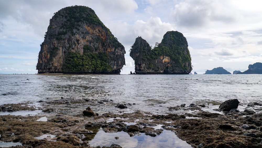 a group of rocks sitting on top of a beach