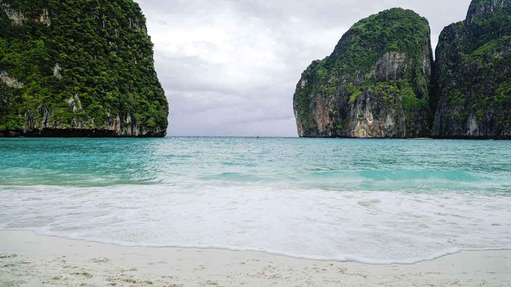 a beach that has some rocks in the water