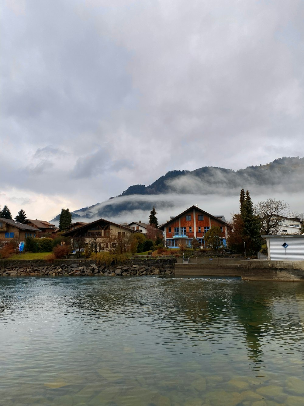 a body of water with houses in the background