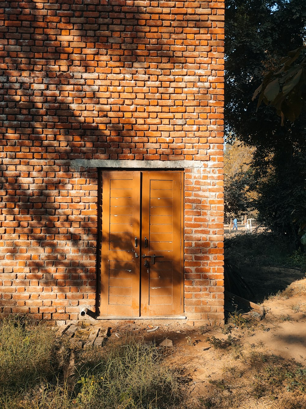 a brick building with two doors and a window