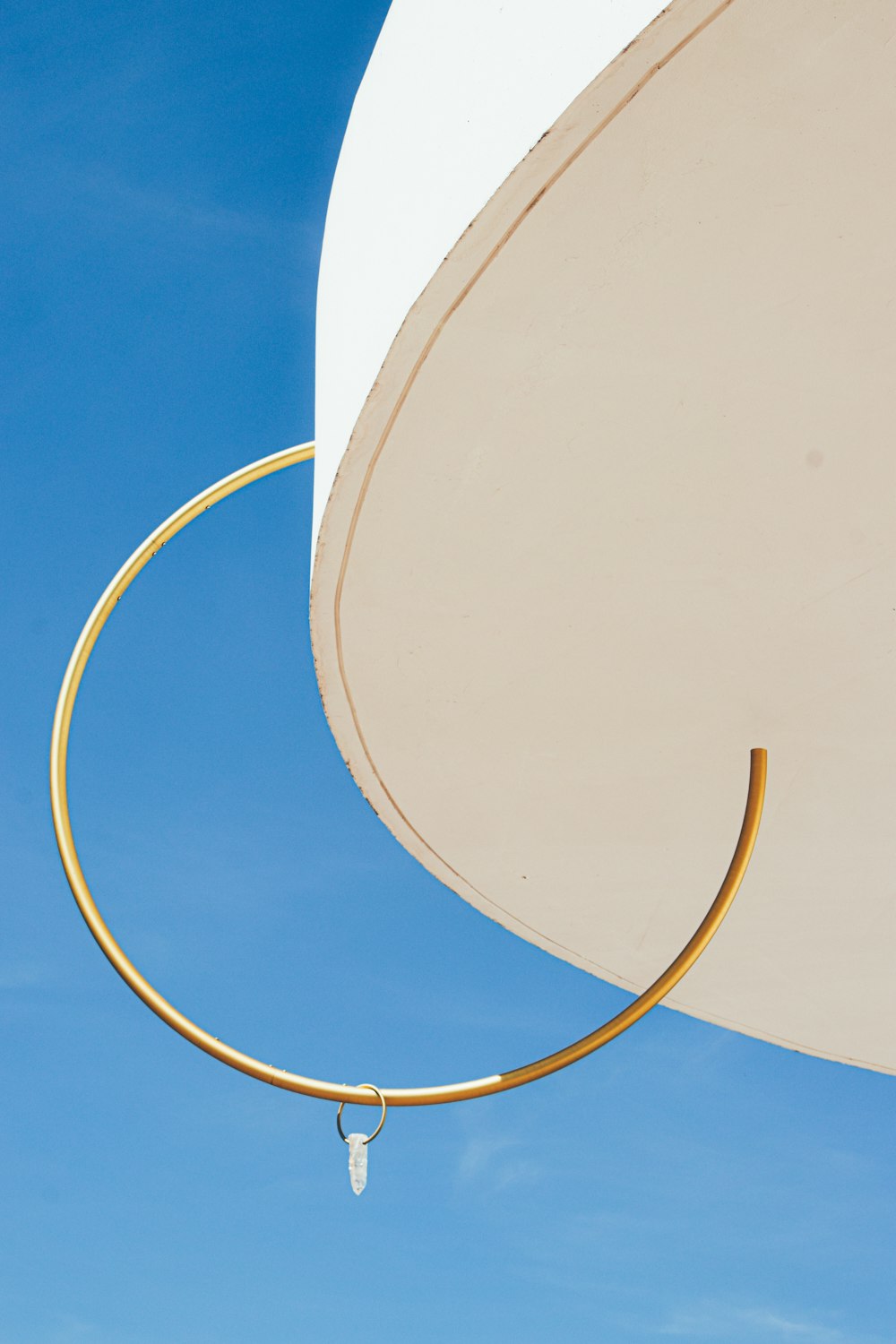 a close up of a white umbrella against a blue sky