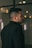 a man in a black jacket looking off into the distance