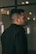 a man in a black jacket looking off into the distance