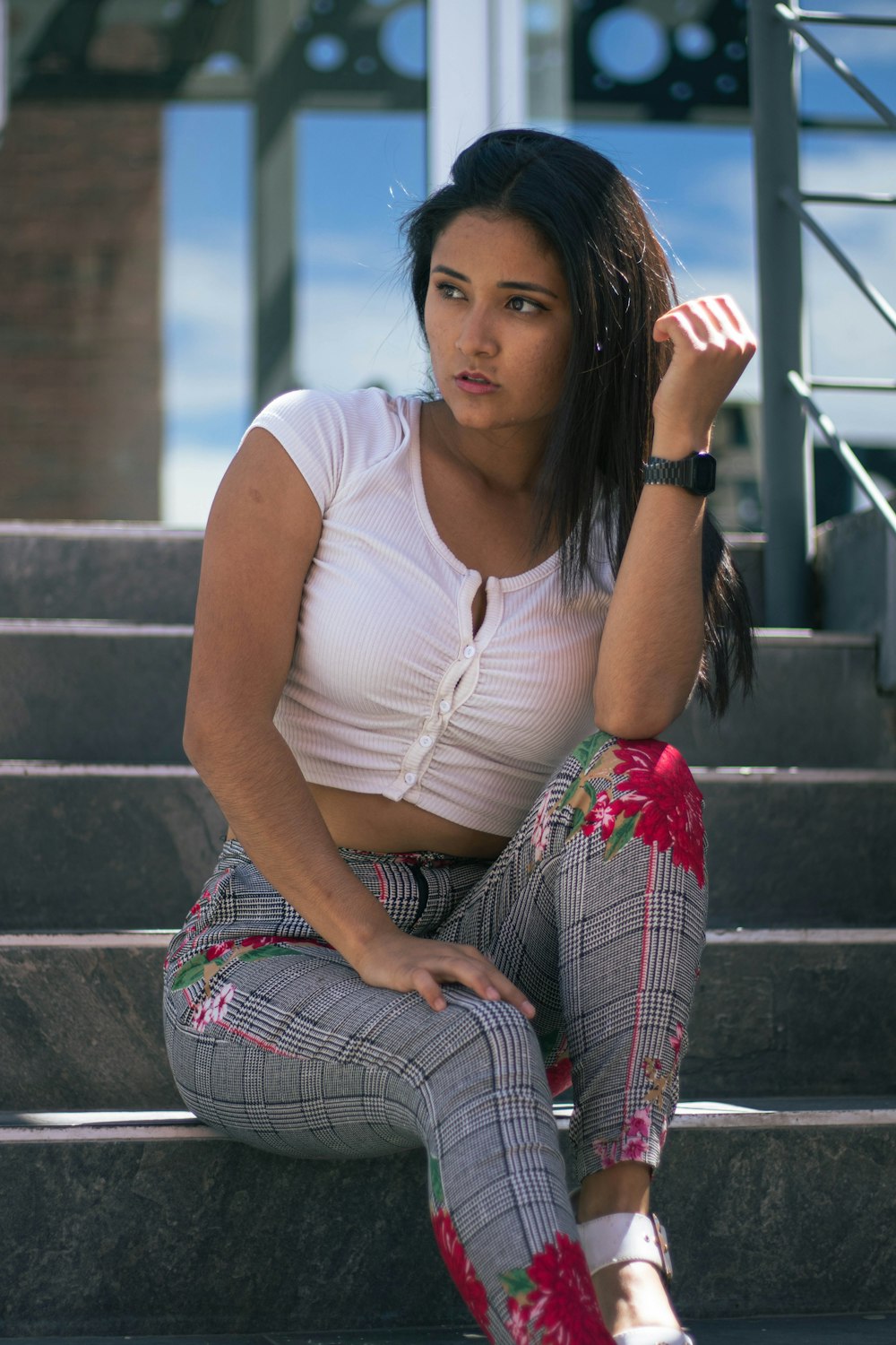 a woman sitting on the steps of a building