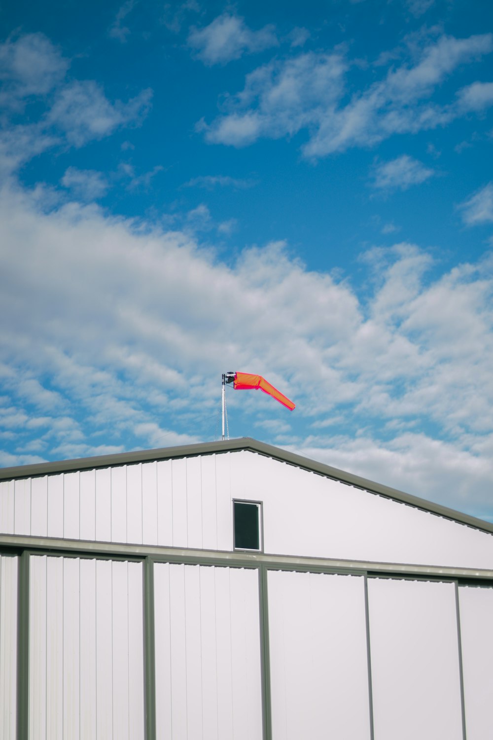 a white building with a flag on top of it