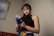 A focused Muay Thai practitioner wrapping hands before a training session in a bright gym.