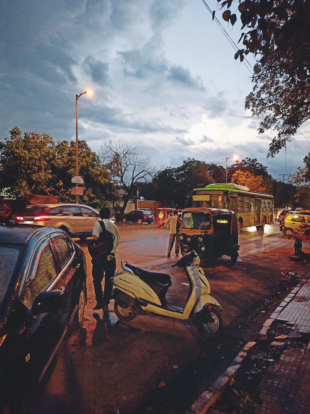 a yellow scooter parked on the side of a road