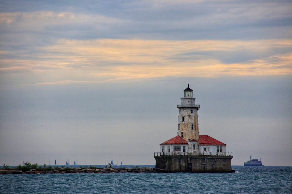 a light house sitting on top of a body of water