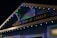 A building facade displaying 'The Royal Bank of Canada' sign, adorned with colorful string lights in blue, red, green, and yellow hues.