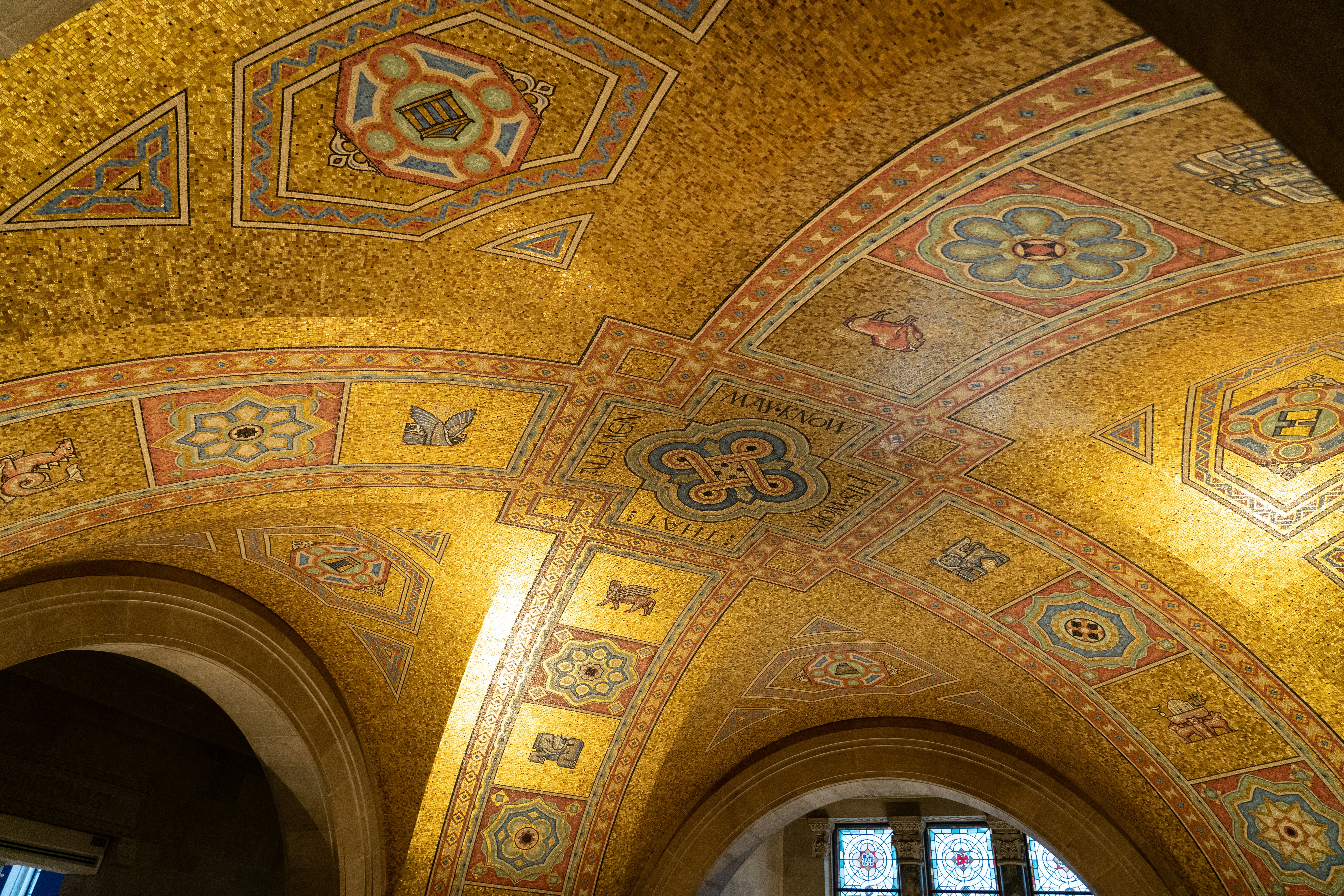 the ceiling of a building with a lot of gold and blue designs on it