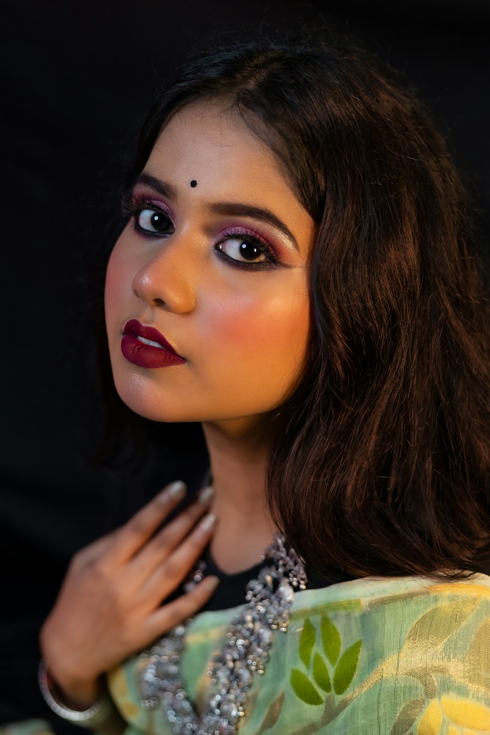 a close up of a person wearing a necklace