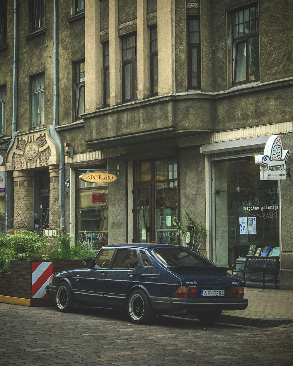 a black car parked on the side of a street