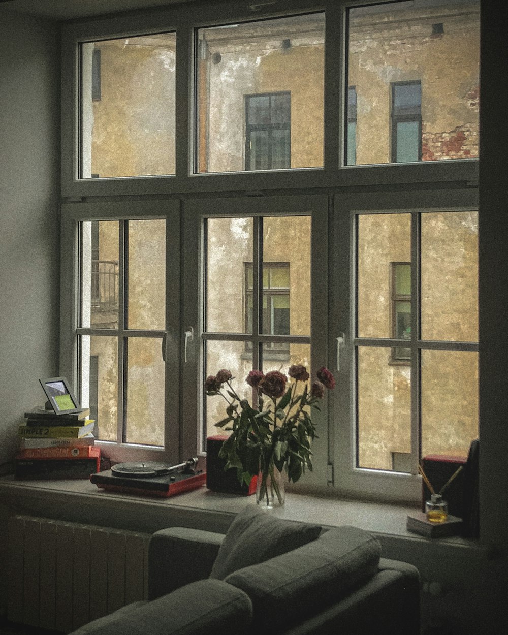 a vase of flowers sitting on a window sill