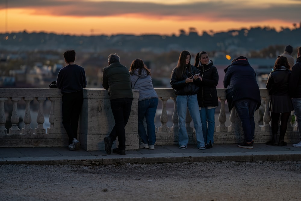 a group of people standing on top of a bridge