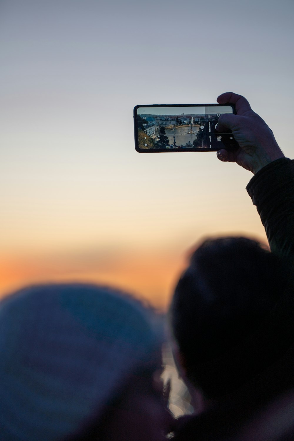 a person taking a picture with a cell phone