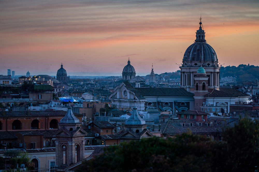 a view of a city at sunset from a hill