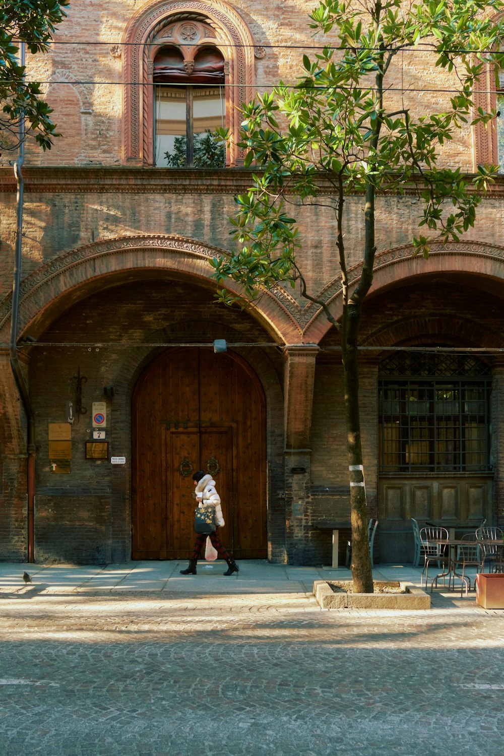 a person walking in front of a brick building