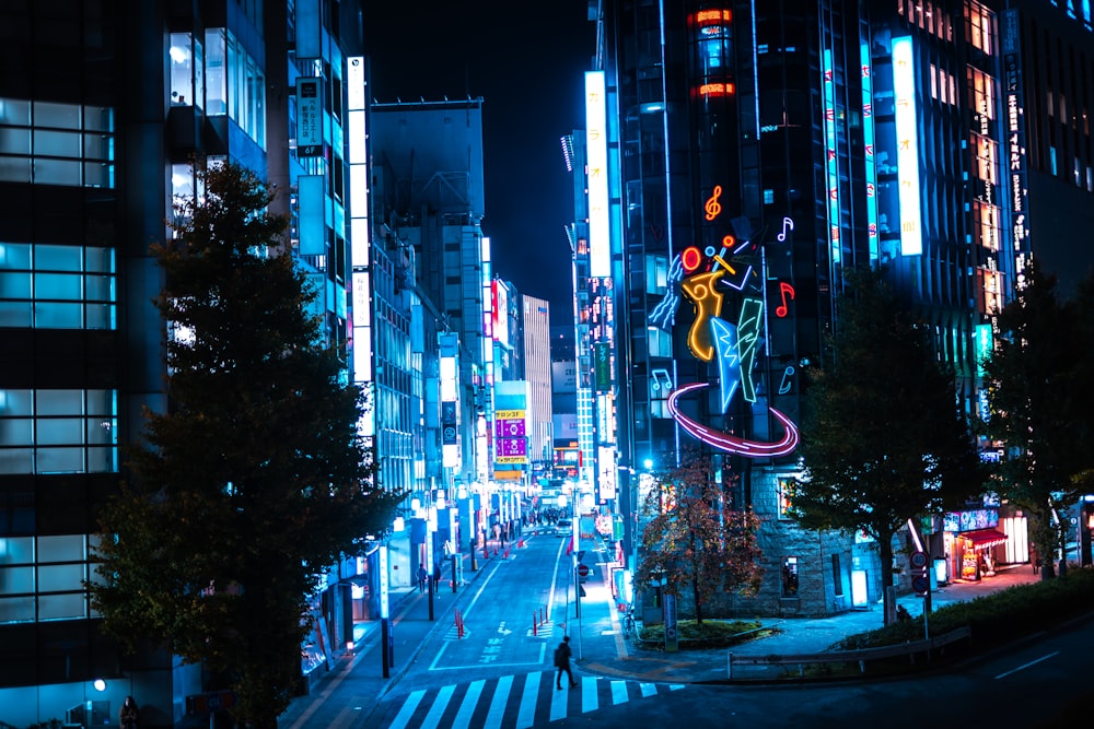 a city street at night with neon lights