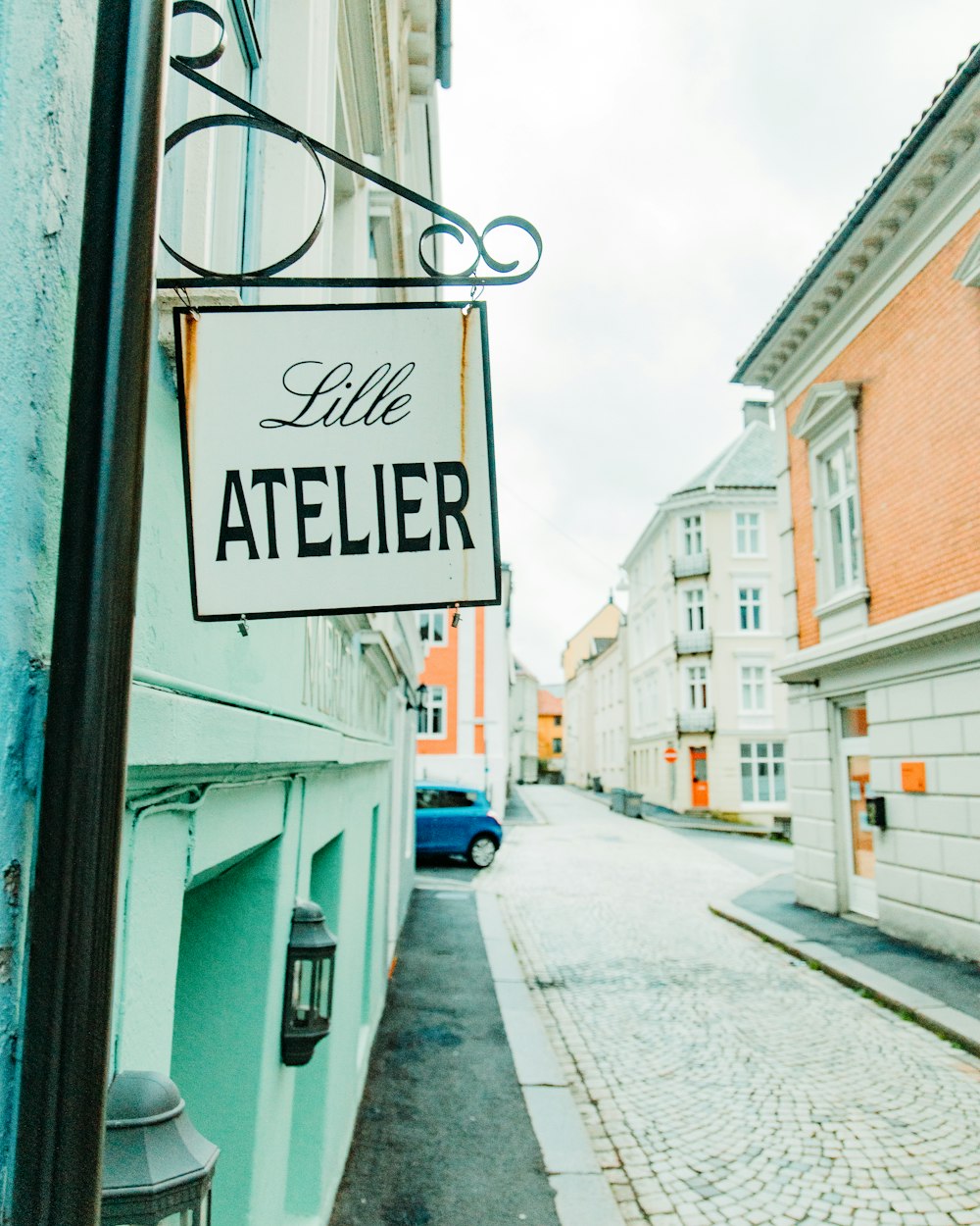 a street sign hanging from the side of a building