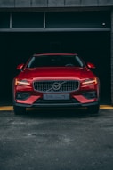 a red volvo car parked in a garage