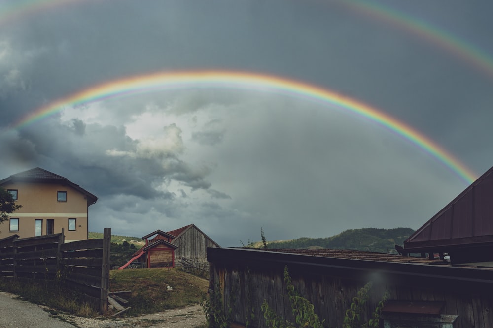a double rainbow is seen over a small town