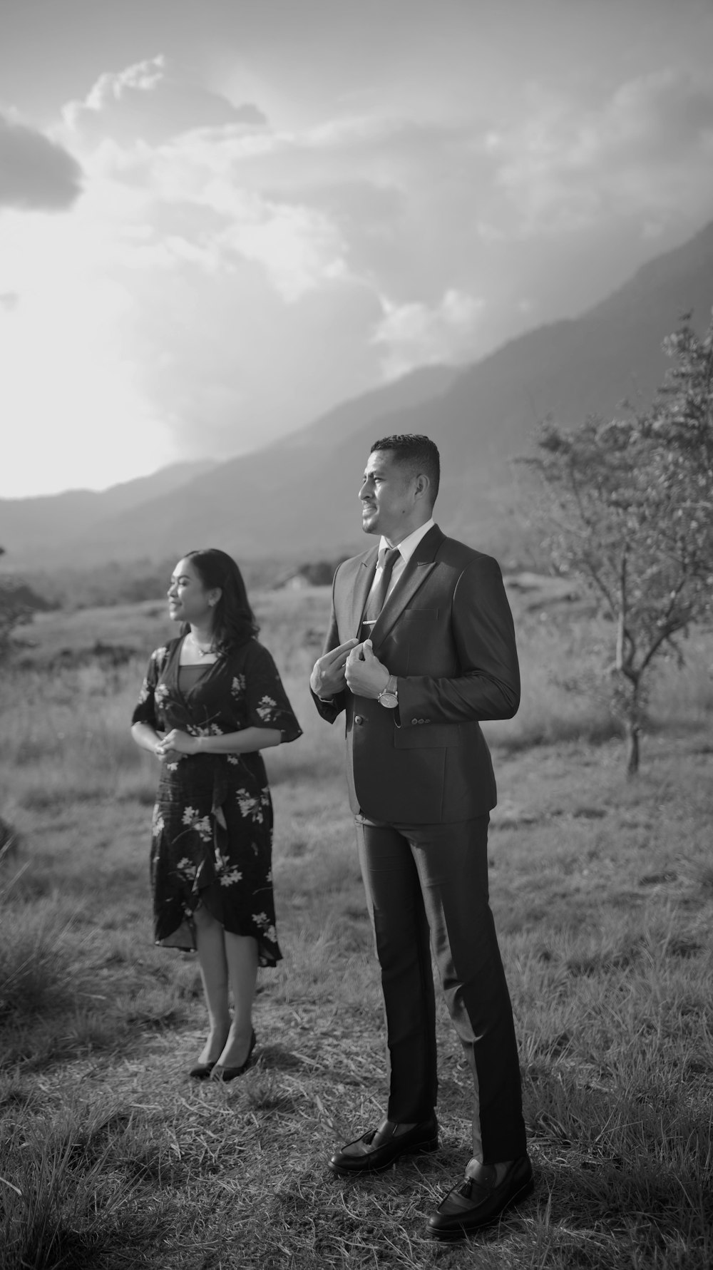 a man and a woman standing in a field