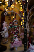 A festive box adorned with colorful Christmas lights and a jolly elf cartoon.