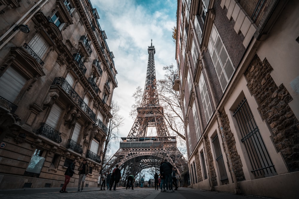 a group of people standing in front of the eiffel tower