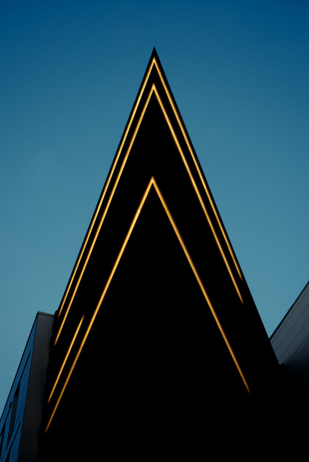 a building with a triangle shaped light on it's side