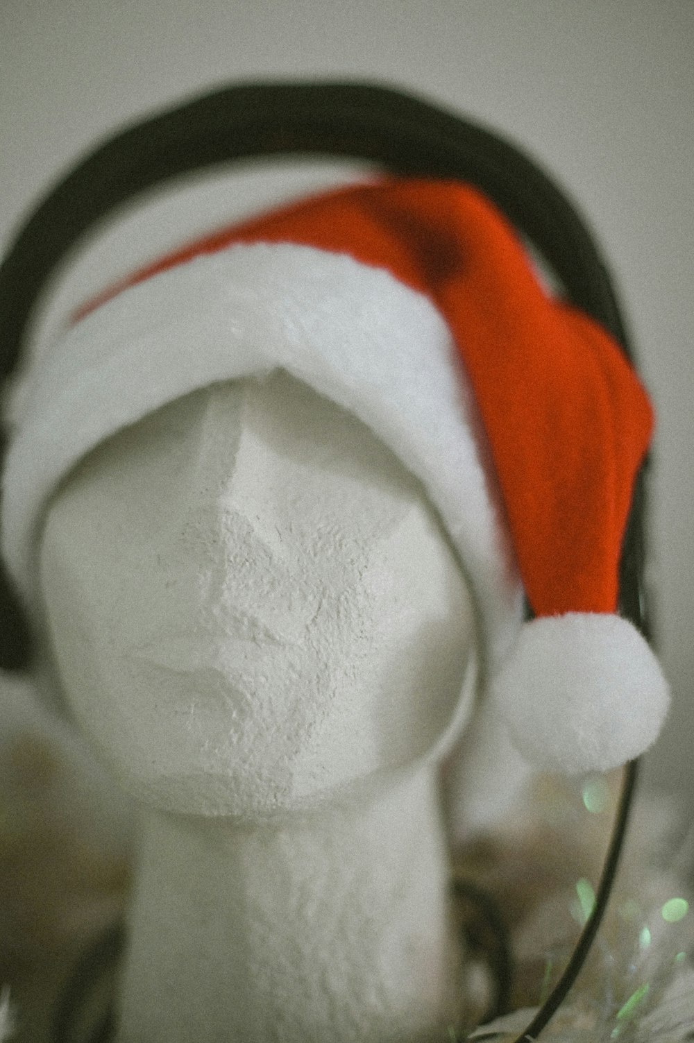a white mannequin wearing a red and white santa hat