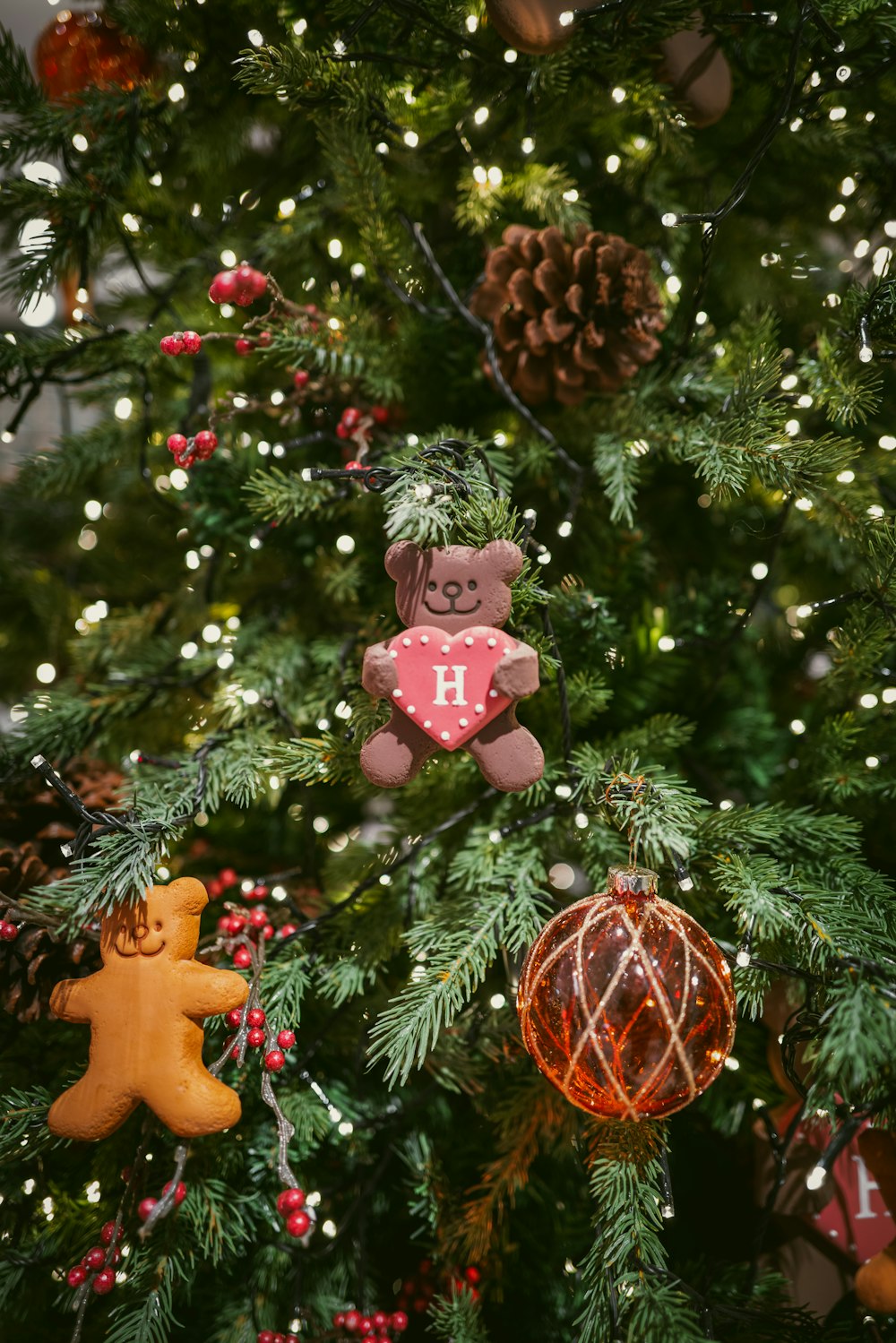 a close up of a christmas tree with ornaments