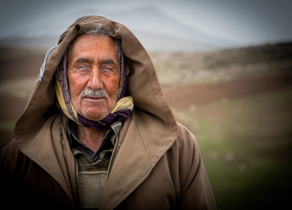 an old man with a hood over his head