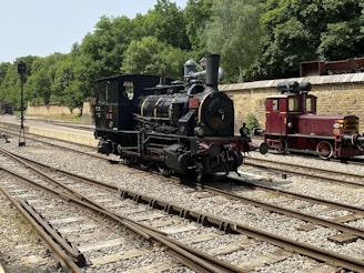 an old fashioned train is on the tracks