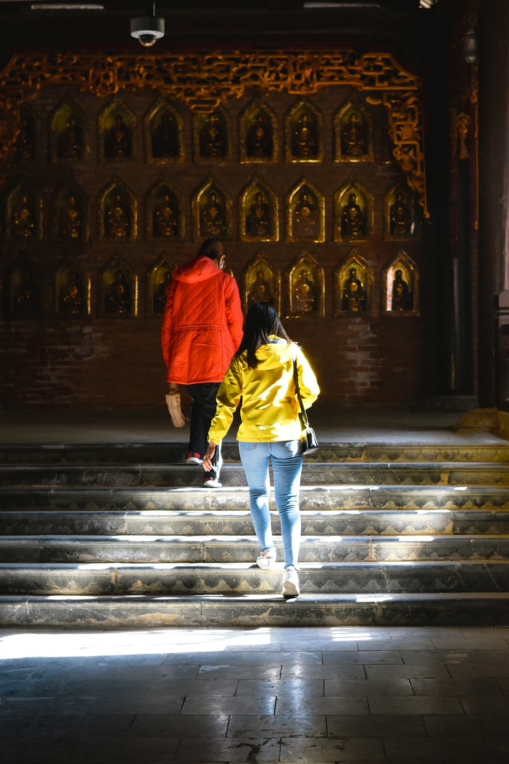 a couple of people walking up some steps