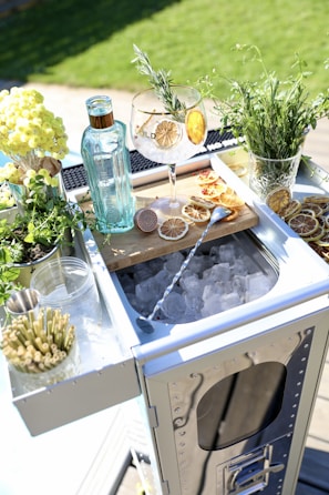 A beautifully arranged drink station with various cocktails and garnishes.