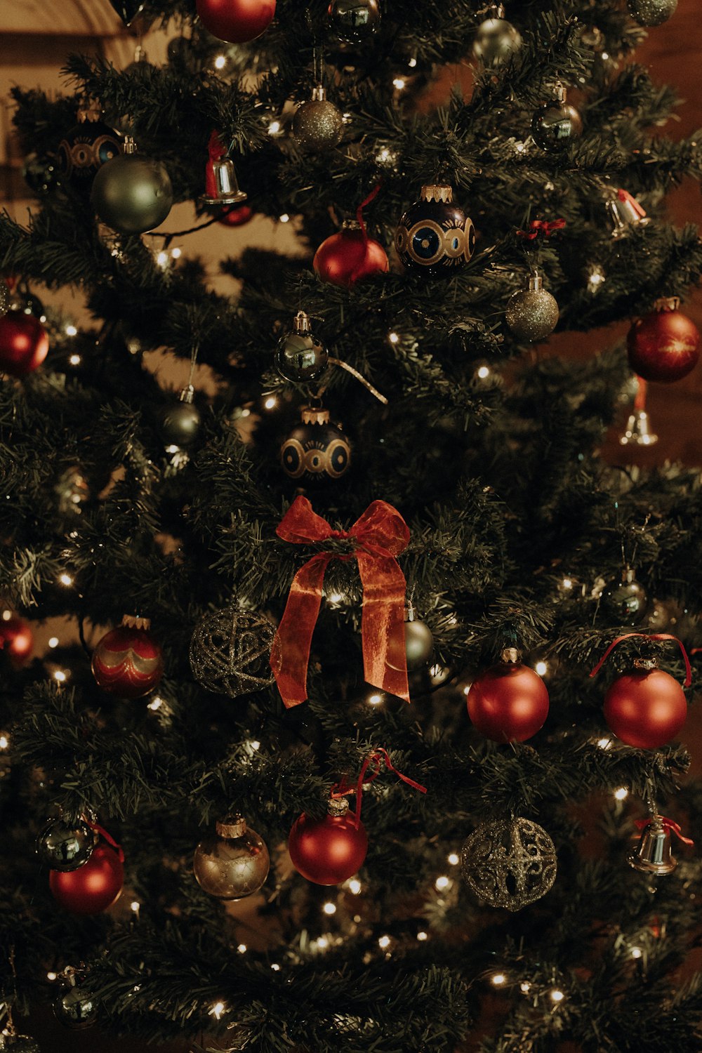 a decorated christmas tree with a red bow